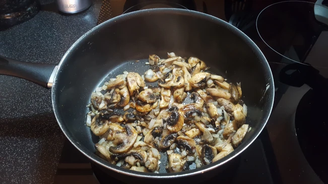 cooked mmushrooms in a pan for mushroom fried rice cooked mushrooms in a pan